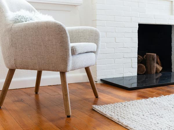 An armchair by the fire in the sitting room